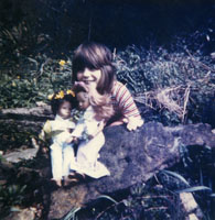 Colour photograph of the upper profile of Gaby Spinks holding her Sasha dolls.