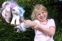 Colour photograph of the upper profile of Riona Shergold holding a toy pony.