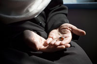 Colour photograph of Shazia Khan's hands holding a ring.