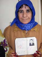 Colour photograph of Munzala Abdullah holding her passport.