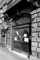 Black and white photograph of the front door of SADACCA.