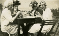 Black and white photograph of Patrick Duggan's mothers family seated at a table, 1920's.