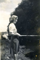 Black and white photograph of Marion Graham fishing in a river, 1940s.