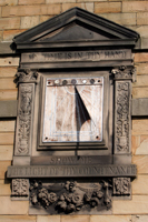 Colour photograph of the sundial on the exterior front wall of Abbeyfield House