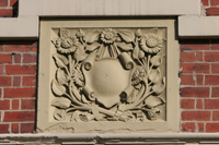 Colour photograph of a carved stone panel on the front exterior wall of the Black Women's resource Centre