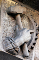 Colour photograph of stone carved panel showing a hand and a hammer at the front of the Sheffield And District African Caribbean Community Association