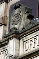 Colour photograph of a carved stone shield above the front porch of Burngreave Vestry Hall