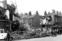 Black and white photograph of bomb damage to houses on Ellesmere Road, 1940.