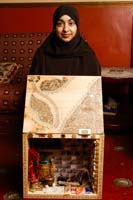 Colour photograph of Sadia Nazir with her memory box, 2006.