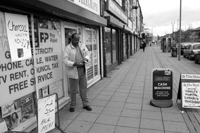 Black and white photograph of the exterior of shops along Ellesmere Road in 2005