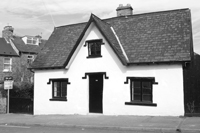 Black and white photograph of the exterior of the White House on Andover Street in 2005