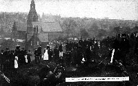 Black and white photograph of people digging for coal above Burngreave Cemetery during the coal strike in 1912