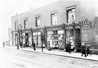 Black and white photograph of shop fronts along Spital Hill in 1910