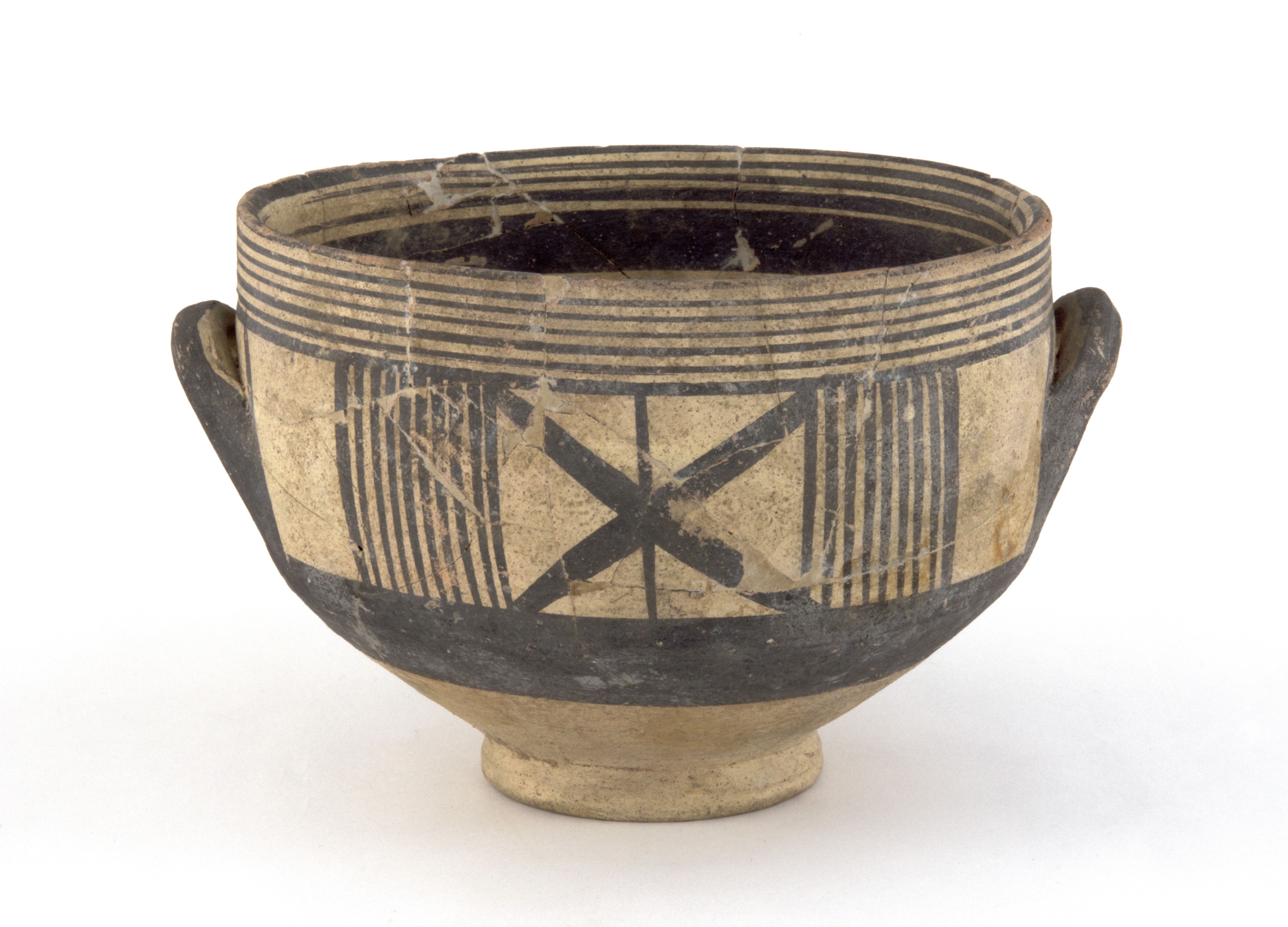 A brown coloured bowl with small handles. It has black line markings of different sizes and going in different directions. There are a few cracks and chips around the top edge of the bowl some of which have noticeable repairs to them.   