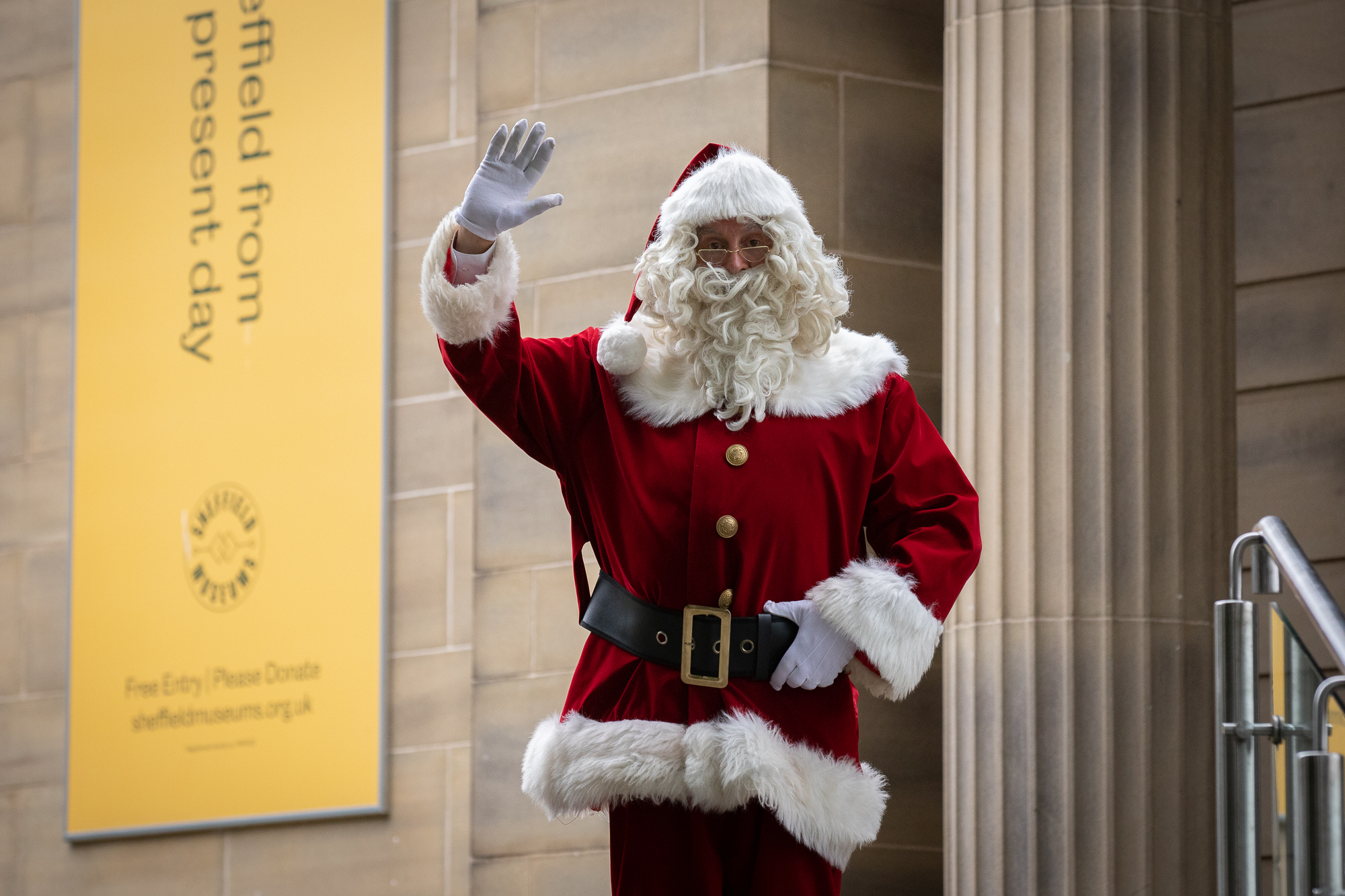 A photograph of Santa waving outside of Weston Park Museum