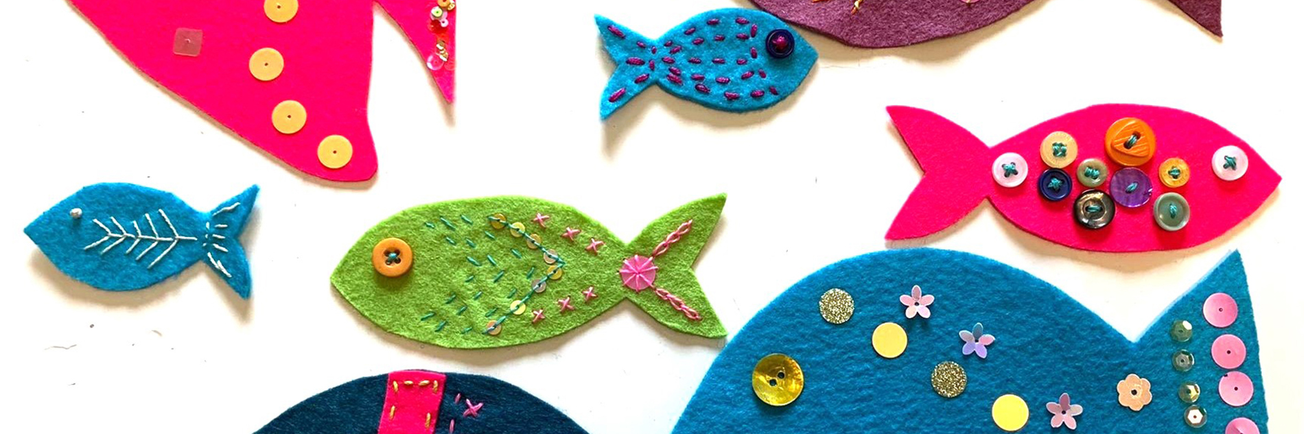 A collection of brightly coloured fish, made from recycled materials. 