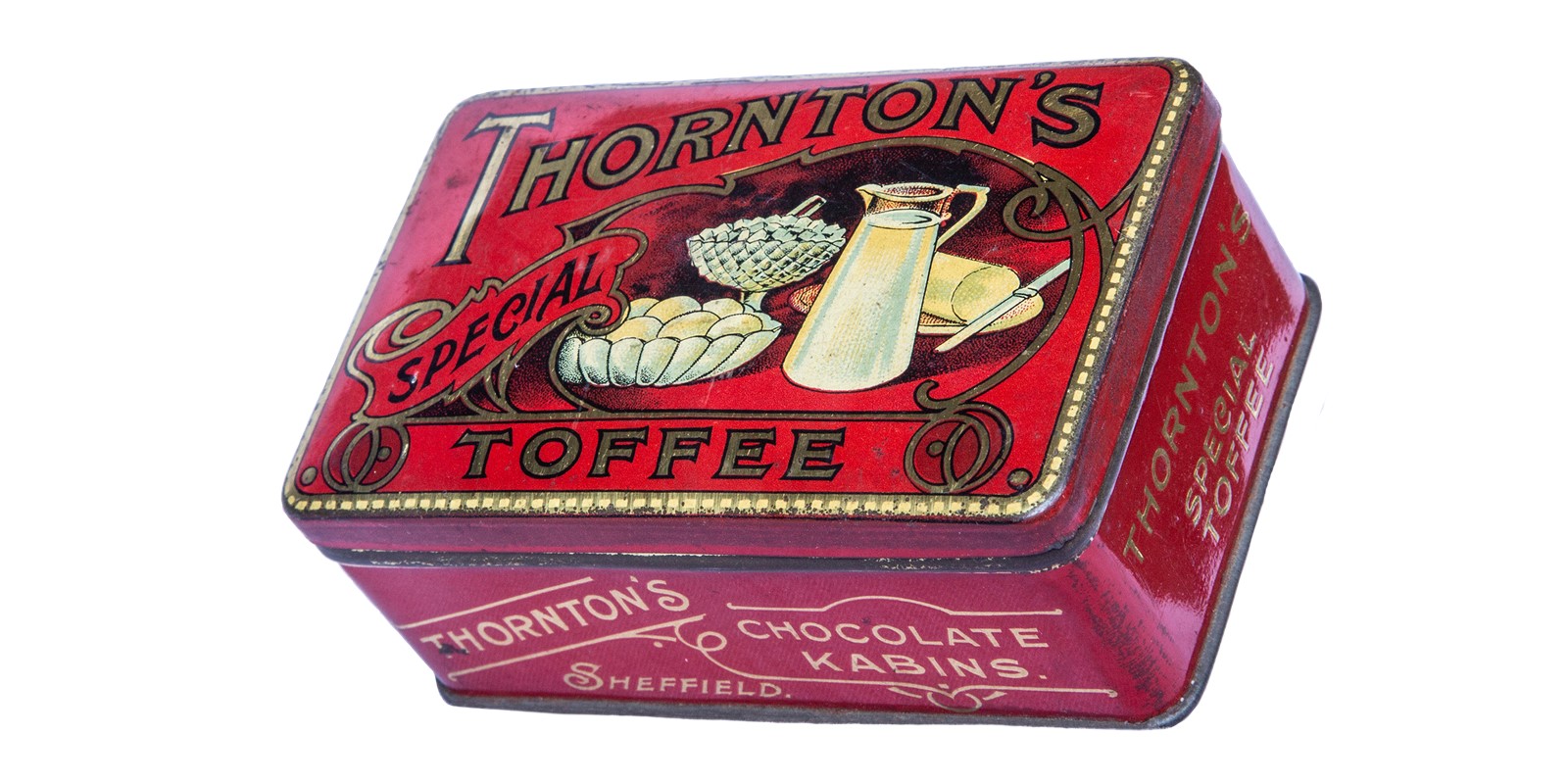 A red tin with the words Thornton's Special Toffee in gold. There is an illustration on the lid of a white jug of milk, a bowl of eggs and a plate of butter with a knife.