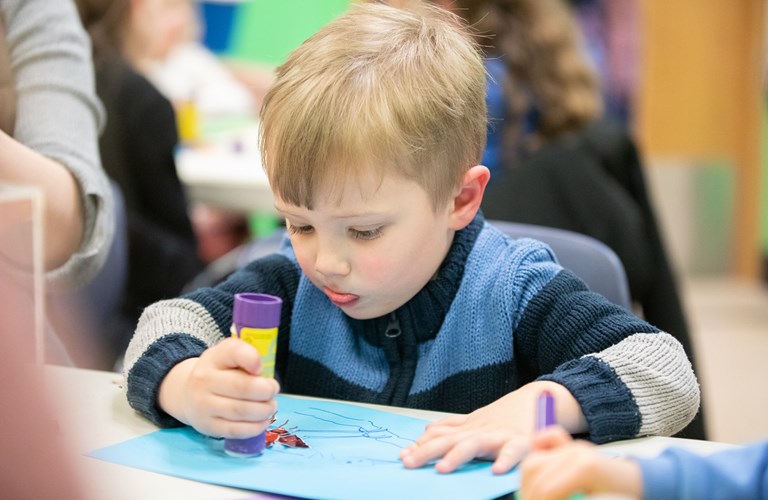 A child taking part in a craft activity.