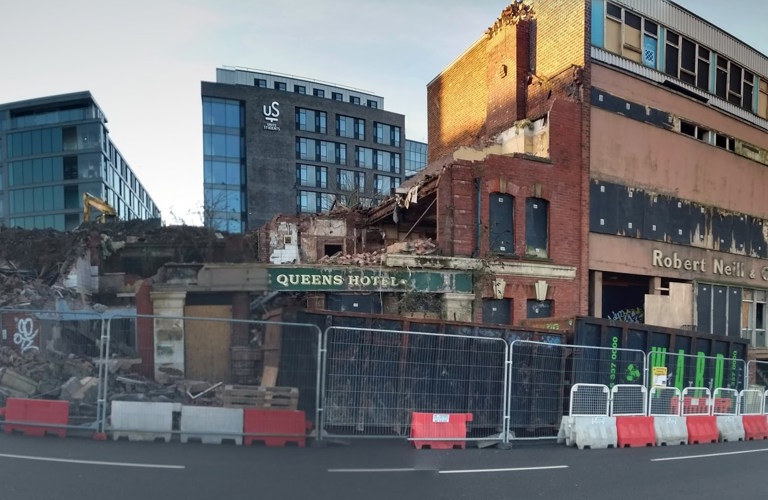 A photograph of a partly demolished building. 