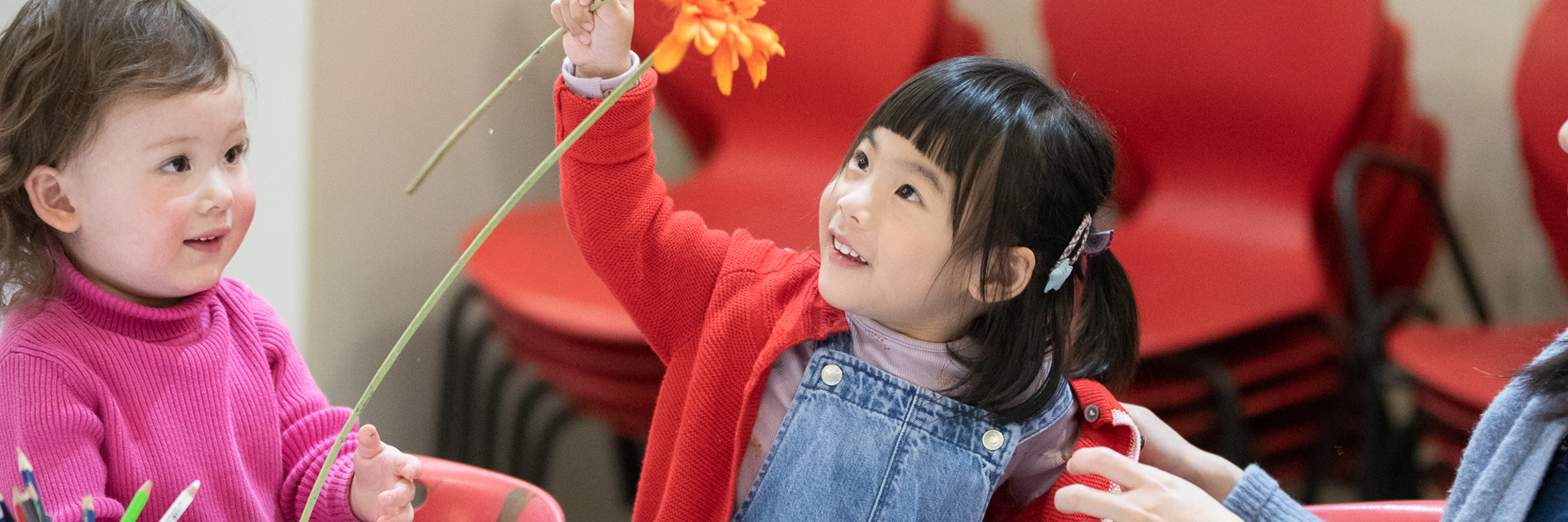 Children playing with flowers as part of a craft activity.