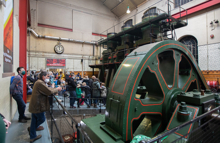 A group of adults and children looking at the River Don Engine. 