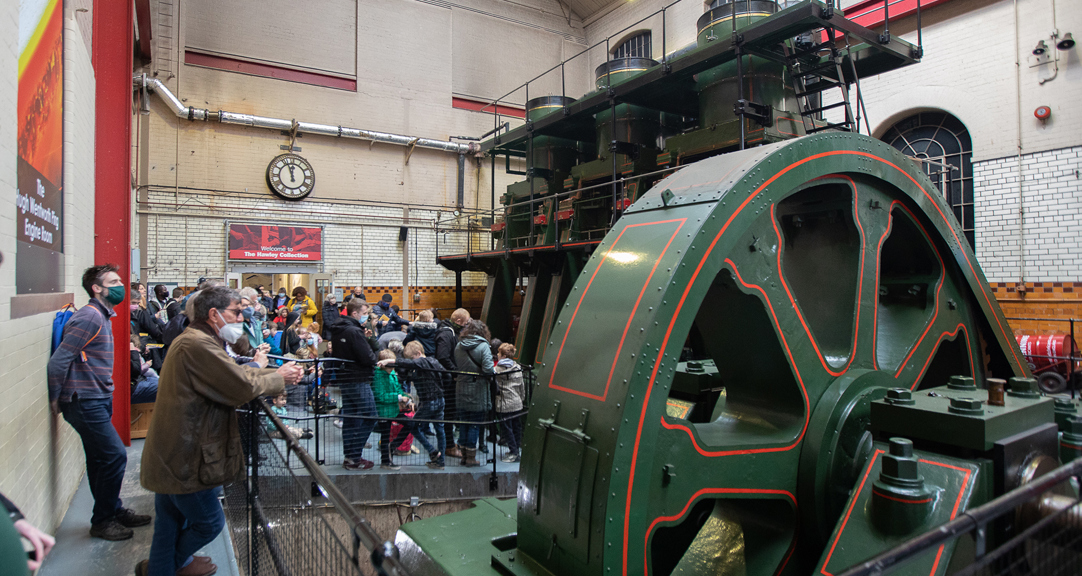 A group of adults and children looking at the River Don Engine. 