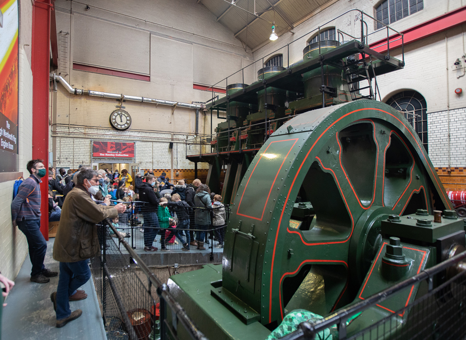 A group of adults and children looking at the River Don Engine. 