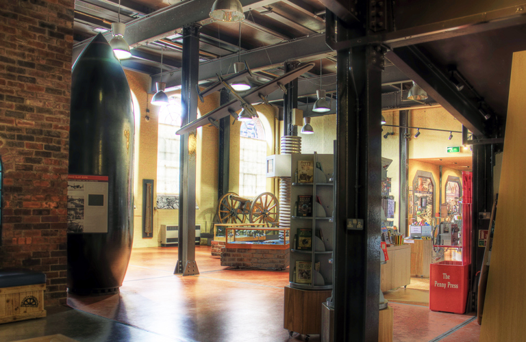 A very large bomb standing vertically on display in the Museum entrance hall.