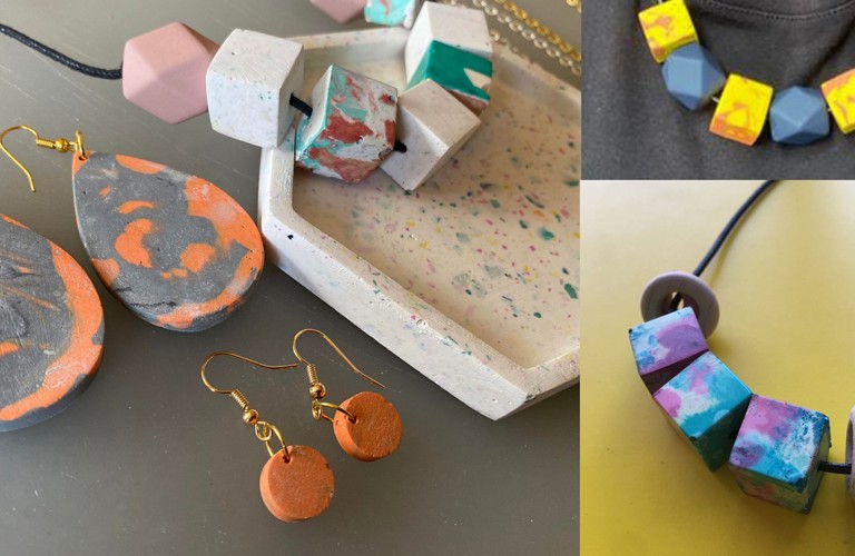 Three photographs of jesmonite crafts arranged in a collage. On the left side, there is one image showing a white jesmonite jewellery tray speckled with other colours, one pair of large orange earrings, and a smaller pair of orange earrings. Top right shows a necklace with chunky yellow and gray beads. Bottom right shows another beaded necklace, this time with chunky blue and purple marbled beads.