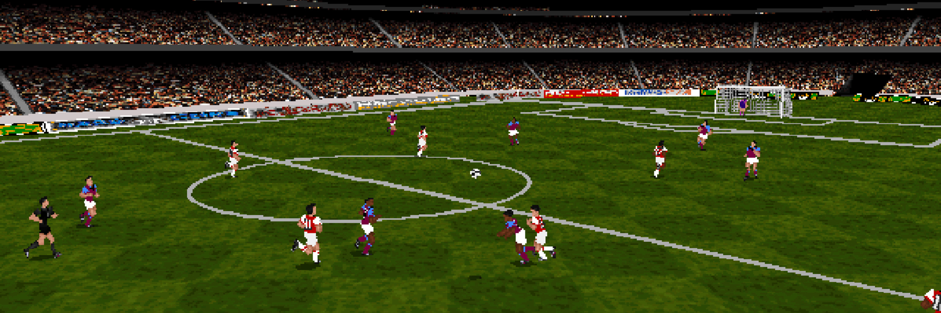 A screencap from the videogame Actua Soccer, showing multiple football players on a football pitch. It is a game from the 90s, so quite pixelated.