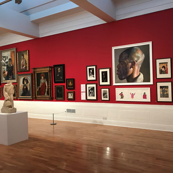 Contemporary and historical portraits on display in a gallery. 