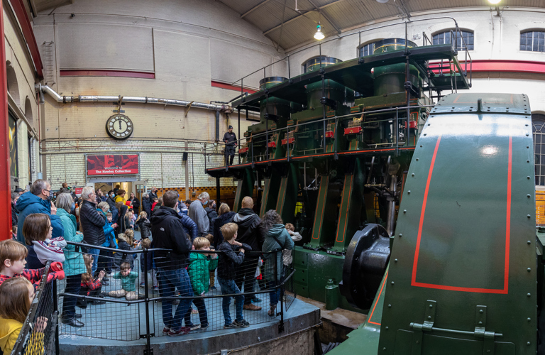 A group of adults and children looking at the River Don Engine. 