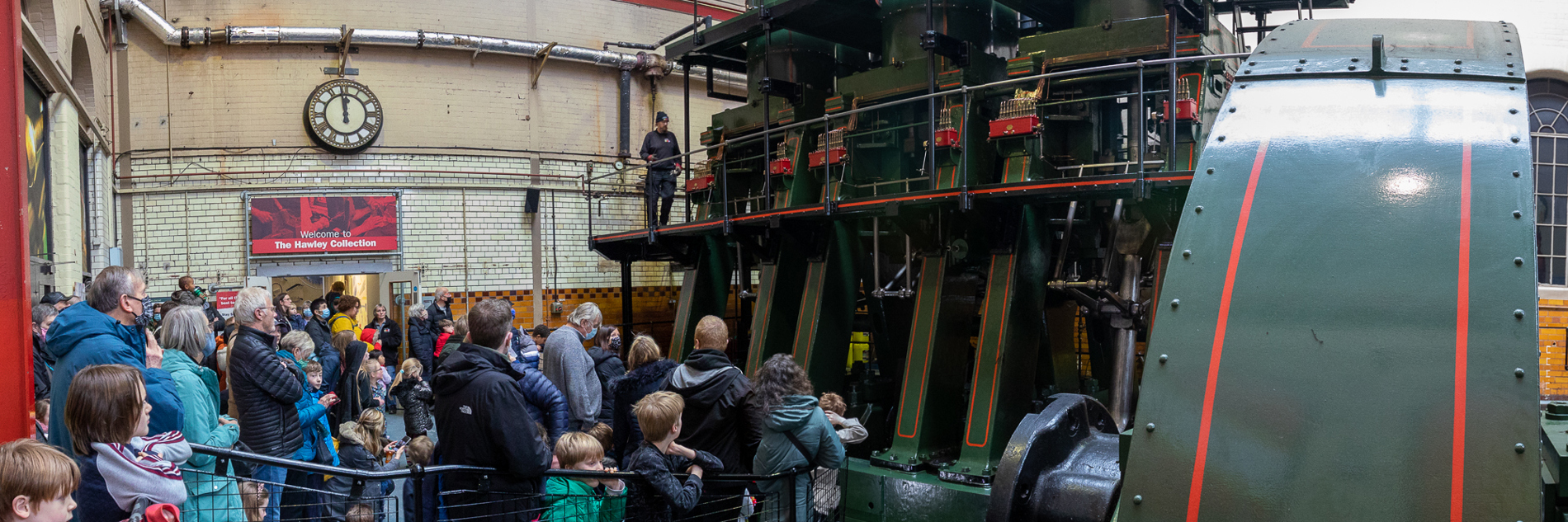 A group of adults and children looking at the River Don Engine. 