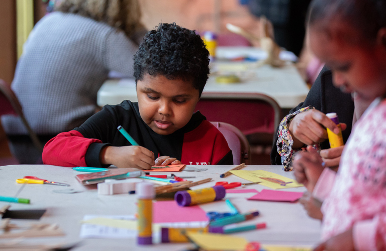 A family taking part in a craft activity.