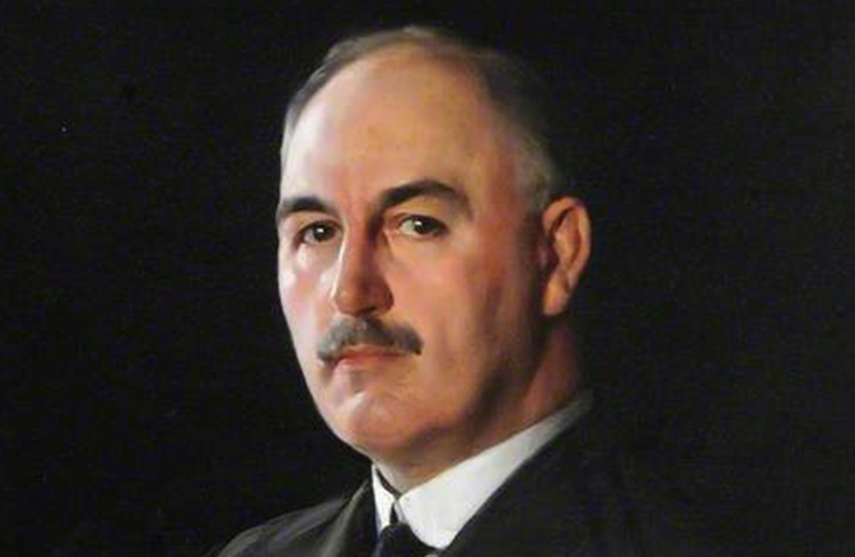 A cropped detail image of a painting of JG Graves, a serious looking man with a moustache and wearing a suit