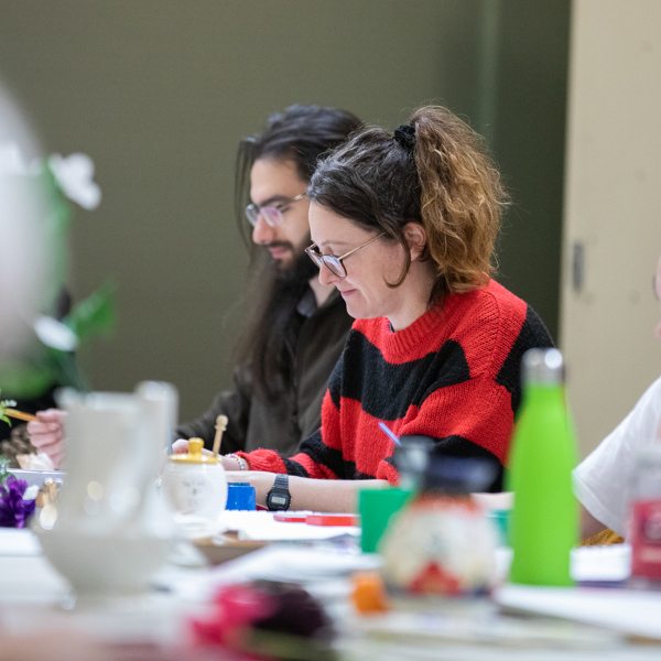 People at a large table taking part in an art activity