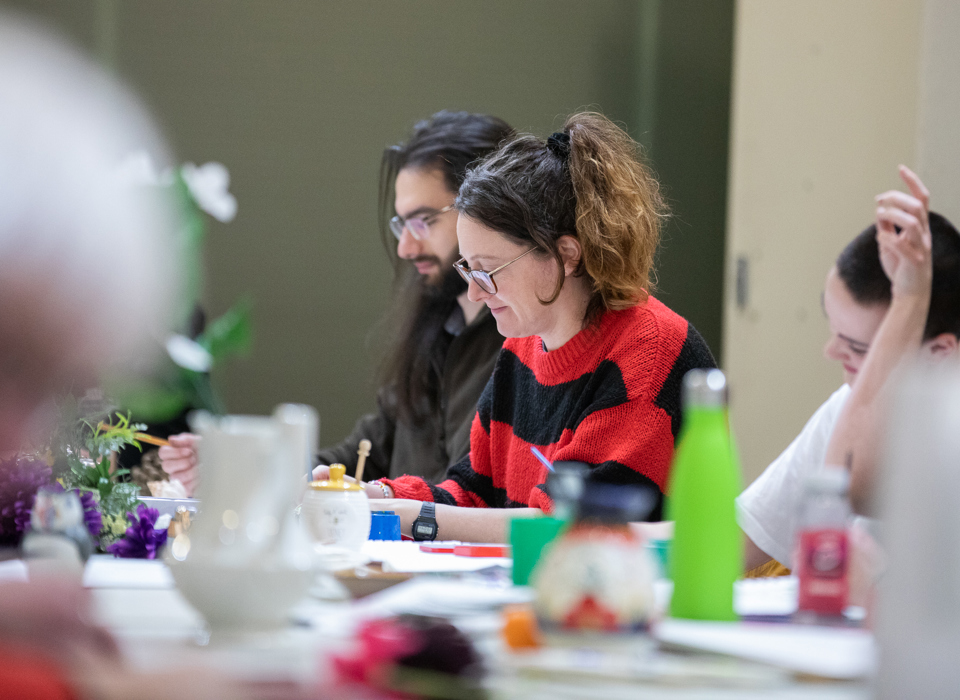 People at a large table taking part in an art activity
