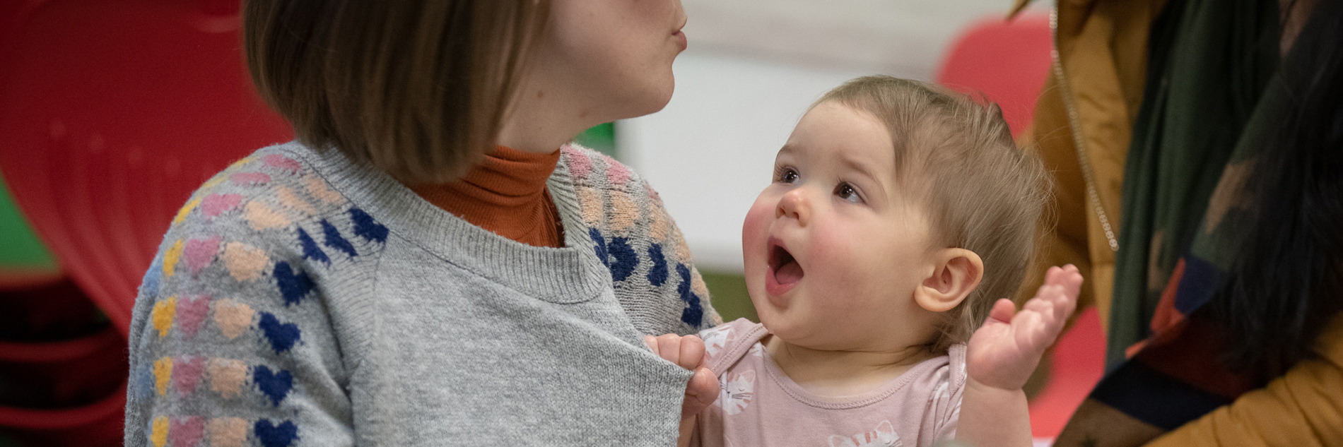 A photograph of a baby looking an adult.