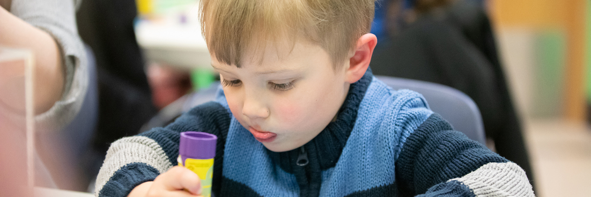 A child taking part in a craft activity.